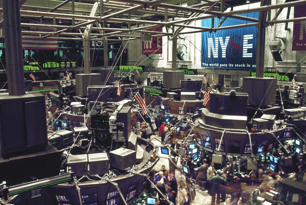 Traders and financial data screens in a busy stock market setting