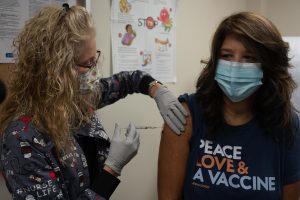 Healthcare worker preparing a measles MMR vaccination dose